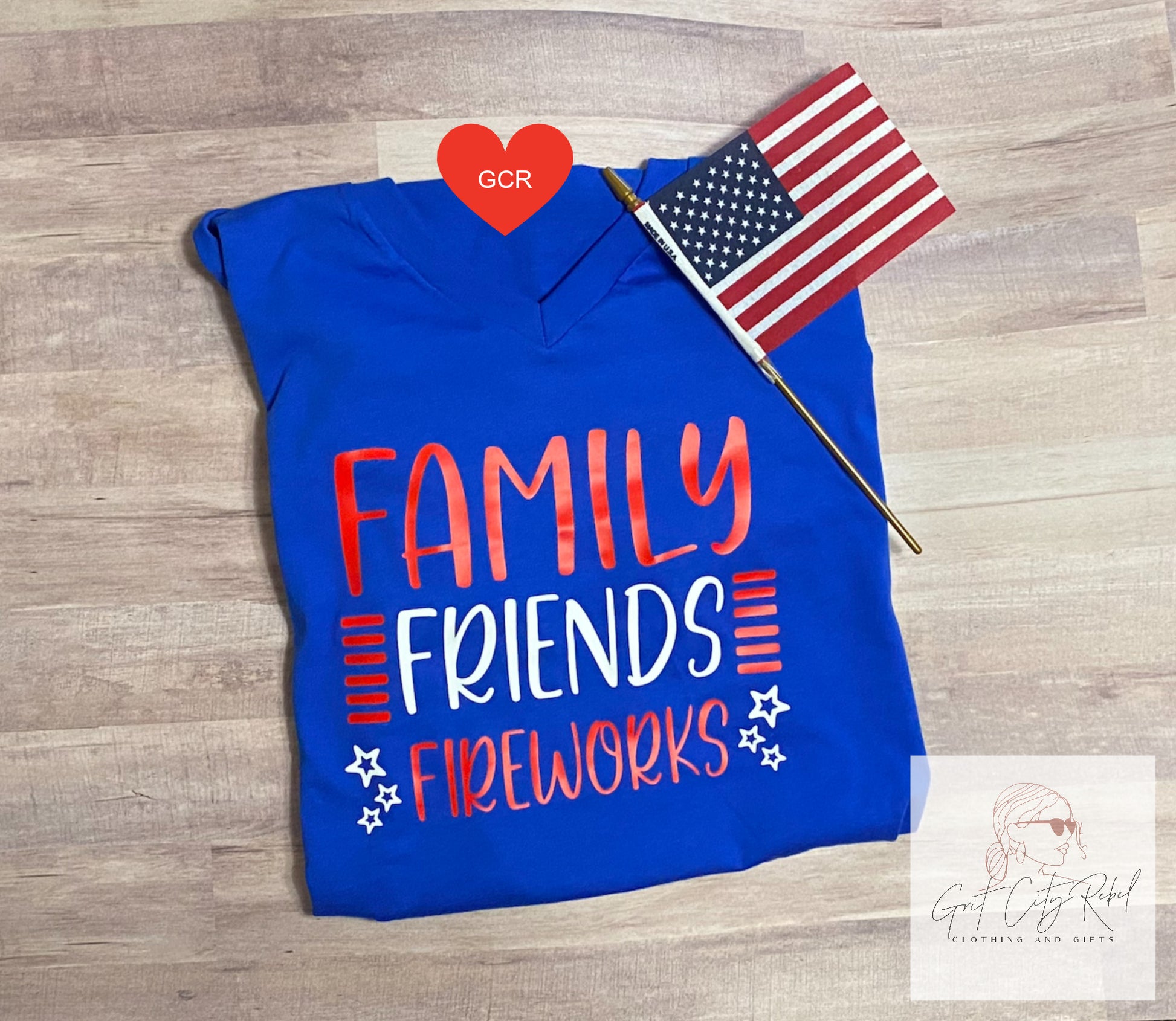 Blue short sleeve unisex T-Shirt  with the saying of Family Friends Fireworks in red white and blue
