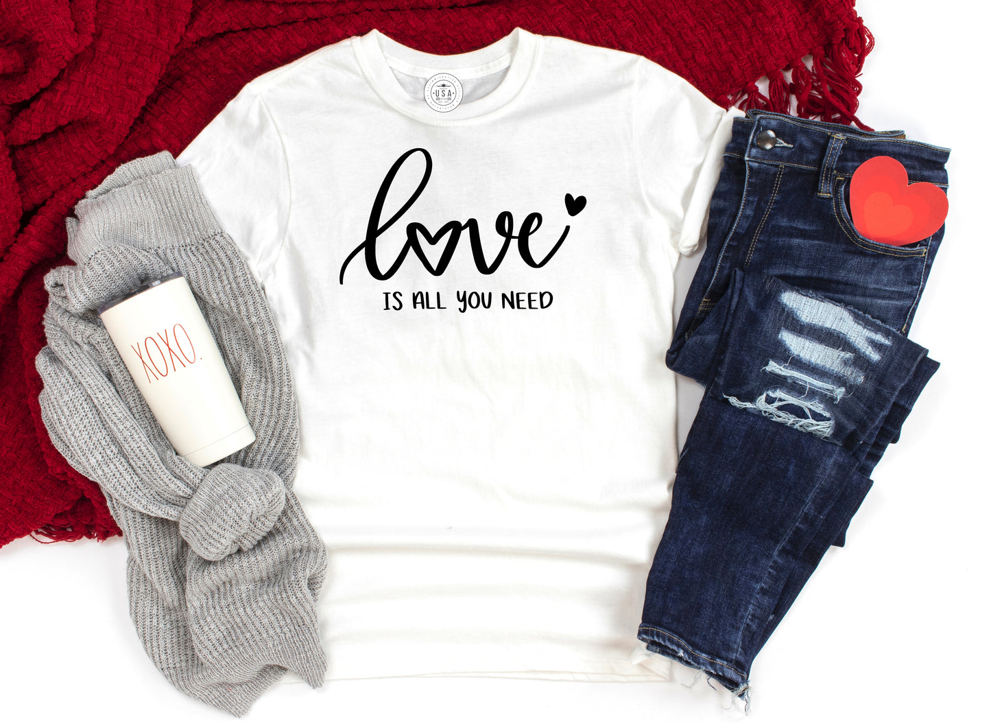 Grit City Rebel white cotton T-shirt with the phrase Love is all you need in black vinyl. Comes in sizes small to 3X