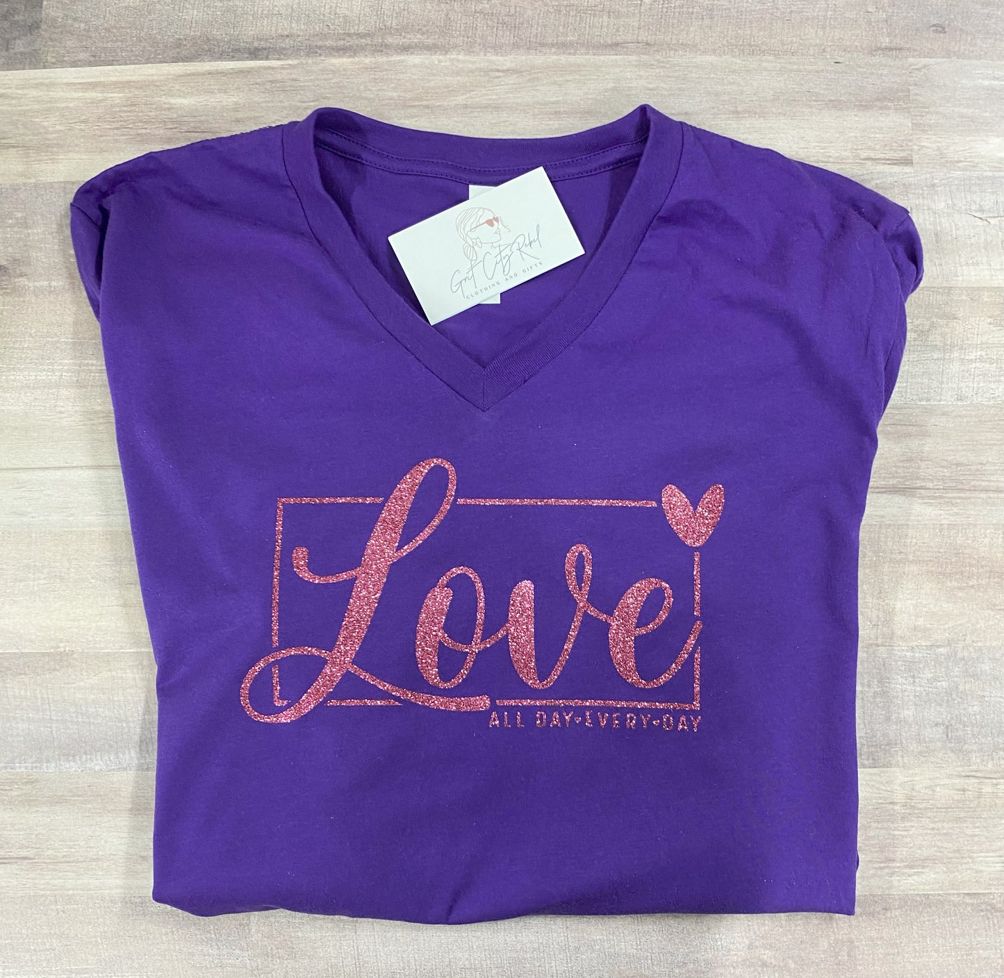 Grit City Rebel January 2025 VIP Monthly T-shirt in purple with the phrase love all day every day in pink glitter in sizes small to 3xl.