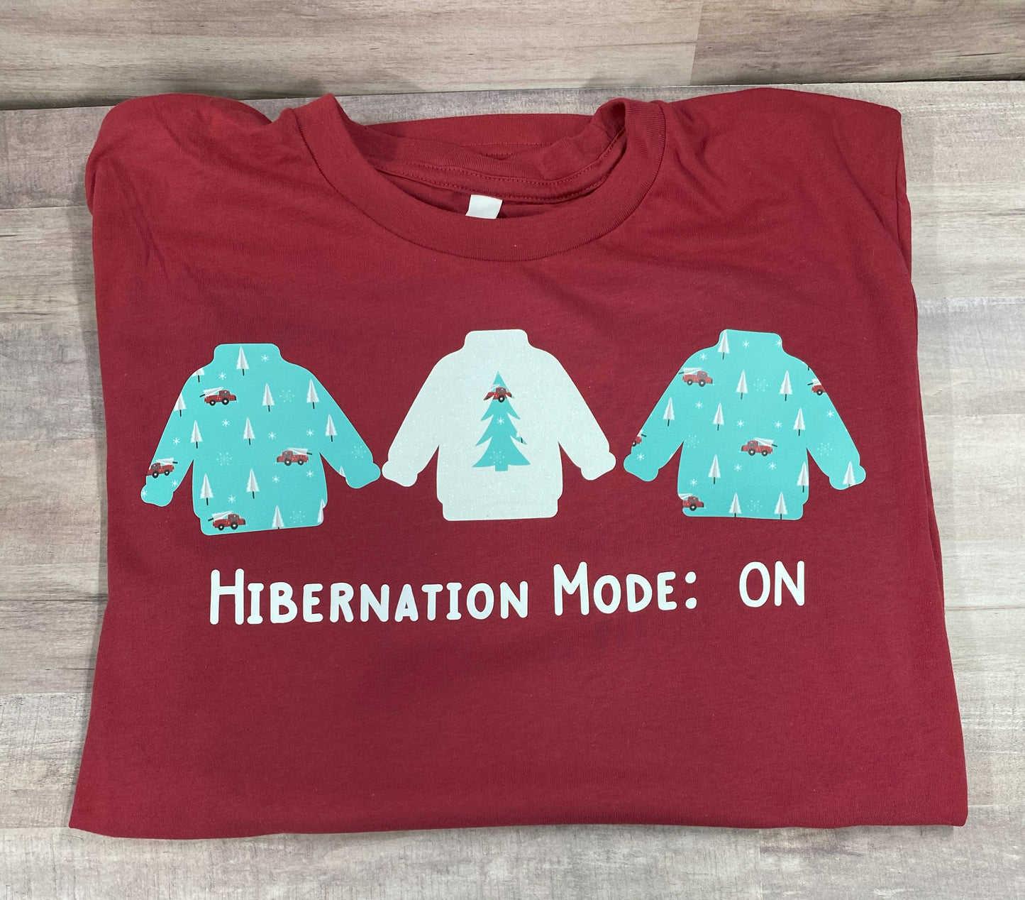 Grit city rebel red unisex t-shirt with the phrase hibernation mode: ON and three sweatshirts. available in sizes small to 3xl