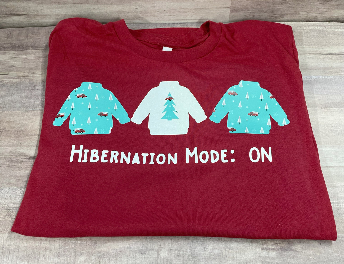 Grit city rebel red unisex t-shirt with the phrase hibernation mode: ON and three sweatshirts. available in sizes small to 3xl