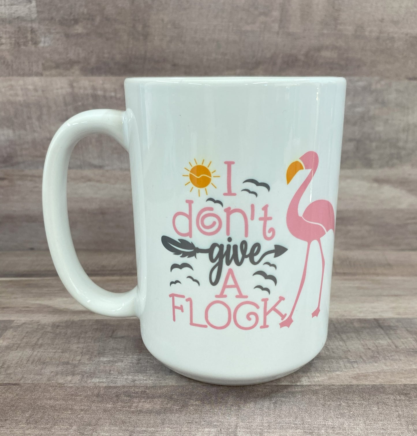 16oz ceramic mug with a pink flamingo image with the phrase i don't give a flock on both side - grit city rebel