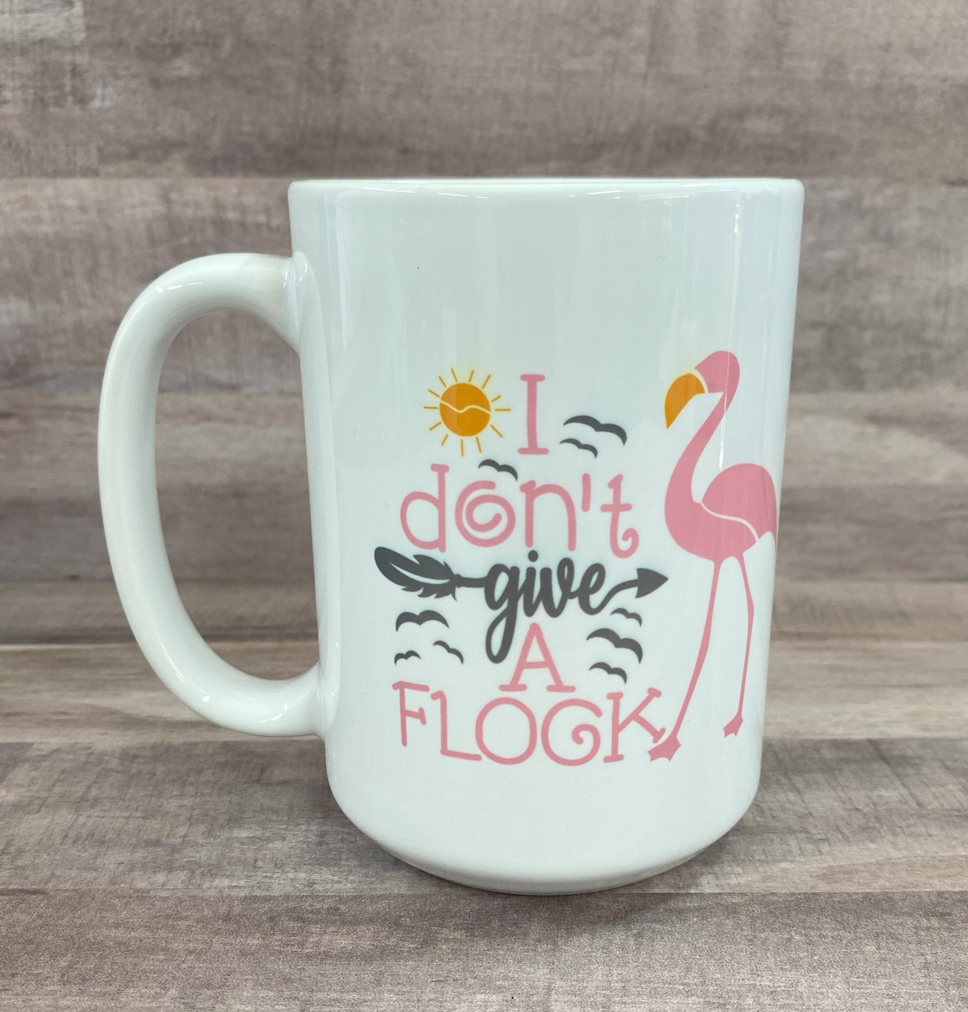 16oz ceramic mug with a pink flamingo image with the phrase i don't give a flock on both side - grit city rebel