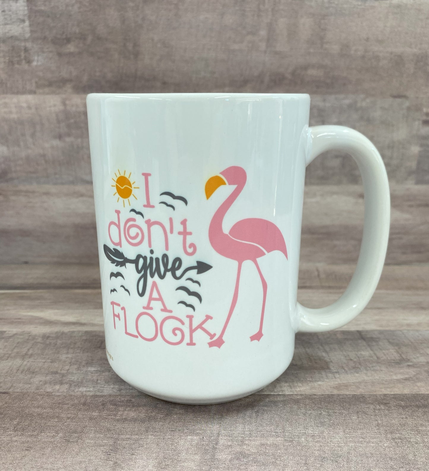 16oz ceramic mug with a pink flamingo image with the phrase i don't give a flock on both side - grit city rebel