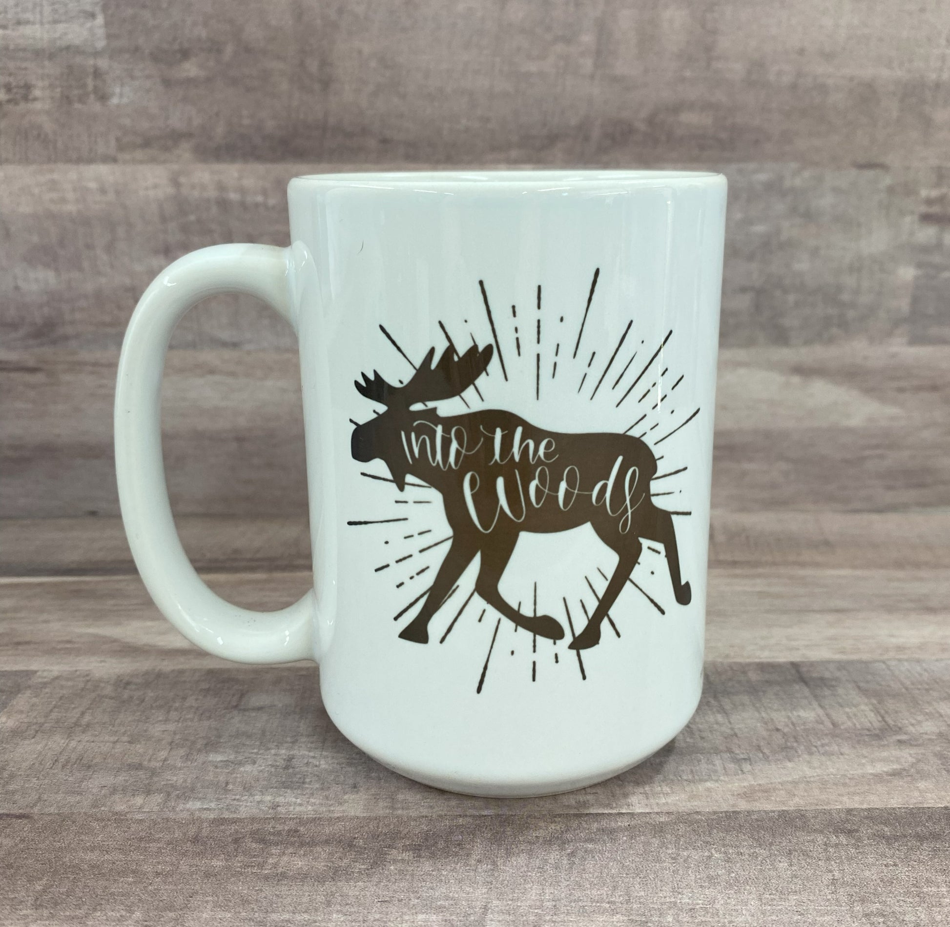 16oz ceramic mug with the image of a moose (in brown) with the phase into the woods (inside the moose image) on both sides of the mug - grit city rebel