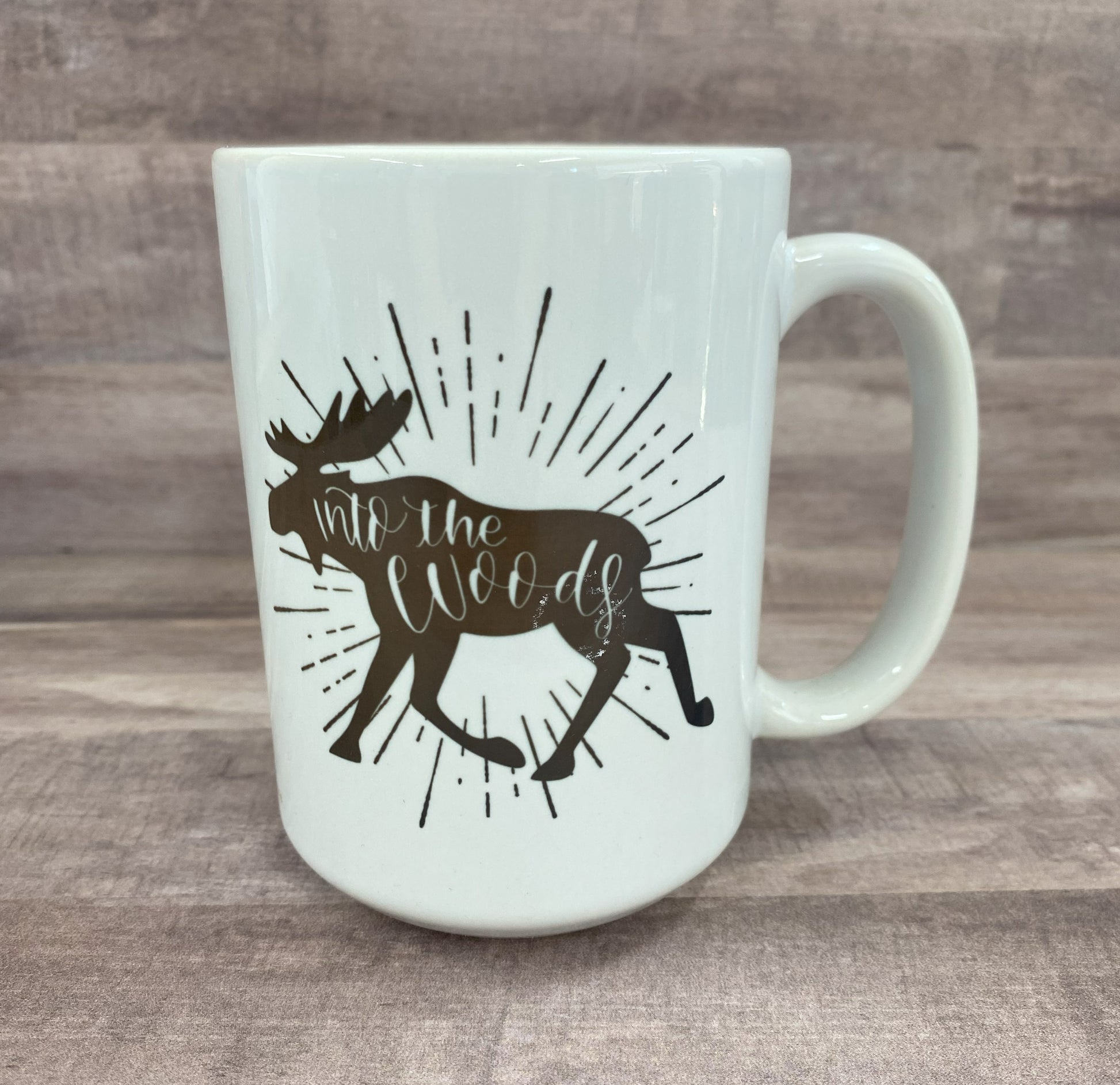 16oz ceramic mug with the image of a moose (in brown) with the phase into the woods (inside the moose image) on both sides of the mug - grit city rebel