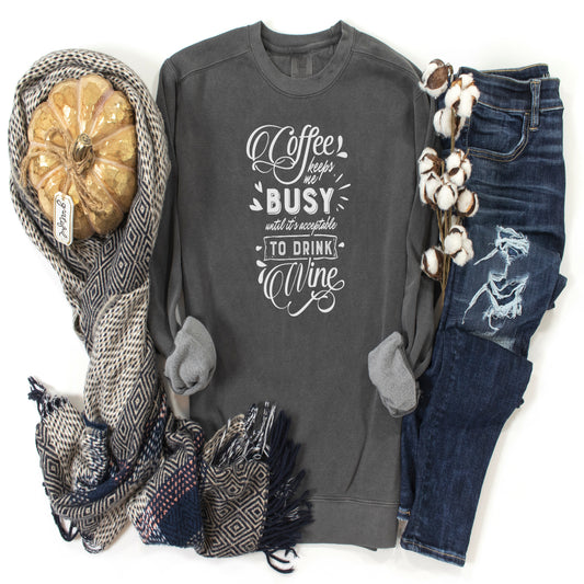 Dark Grey long sleeve unisex sweatshirt with the saying Coffee keeps me BUSY unti it's acceptable to Drink WINE in white writting