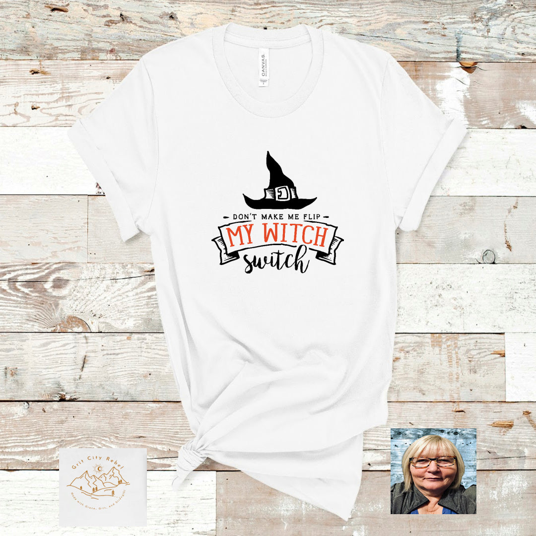 White Tshirt with Black witch hat and the saying Don't make me flip my witch switch in black and orange