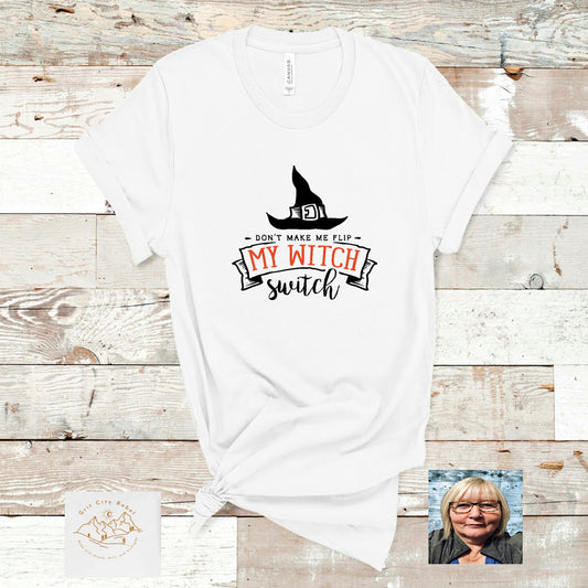 White Tshirt with Black witch hat and the saying Don't make me flip my witch switch in black and orange