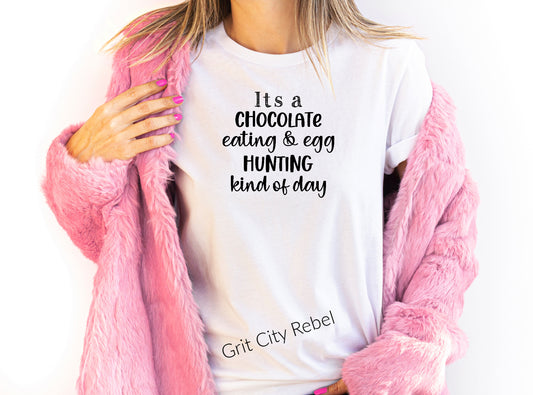 White short sleeve TShirt with the saying It's a Chocolate eating & egg HUNTING kind of day in black writing