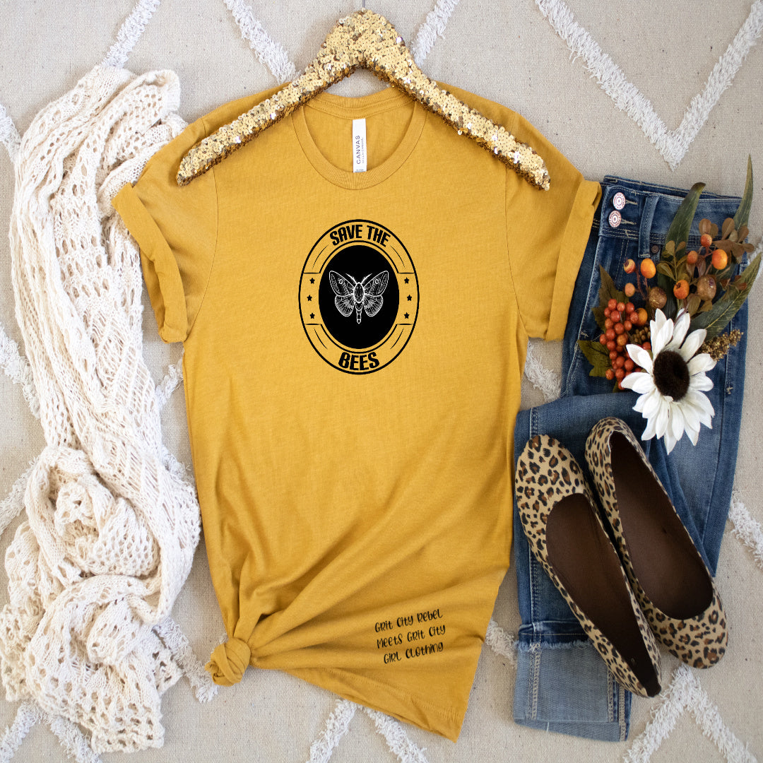 Golden yellow T-Shirt with a bee on a black oval and the saying around the oval Save The Bees unisex T-Shirt