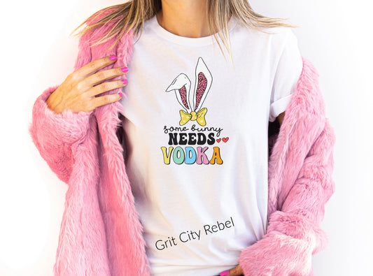 Some bunny needs vodka in paste colors with bunny ears on a white unisex Tshirt