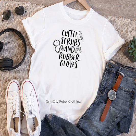 White unisex Tshirt with the saying Coffee, Scrubs, And Rubber Gloves. Has a nurse hat and syringe accents.