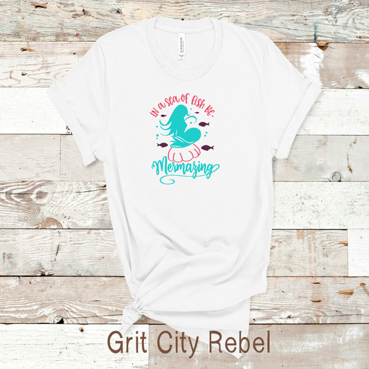 In a sea of fish be mermazing red and teal on a white Tshirt