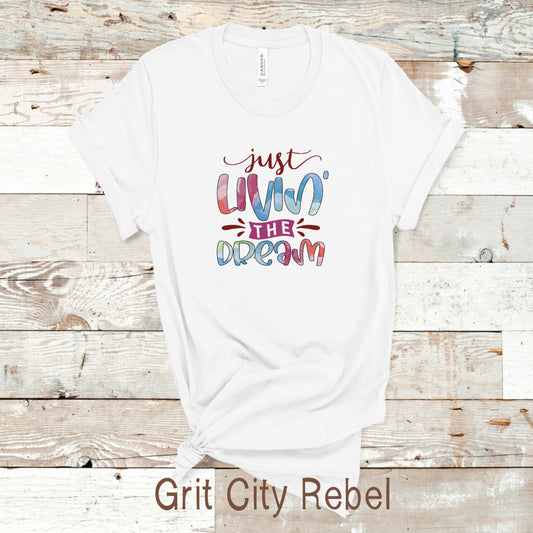 Just livin the dream white TShirt with coloed lettering sizes small, medium, large, Xlarge, 2X, 3X