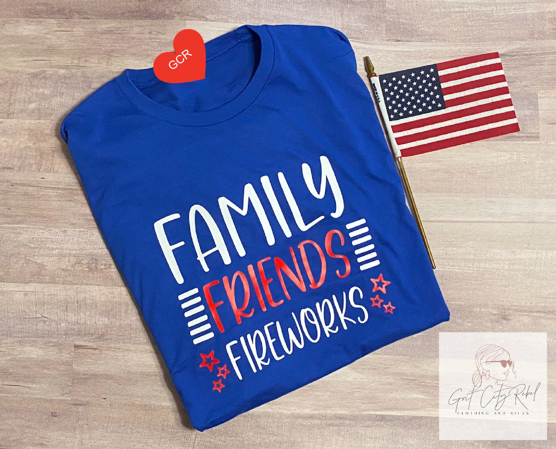 Blue short sleeve unisex T-Shirt  with the saying of Family Friends Fireworks in red white and blue