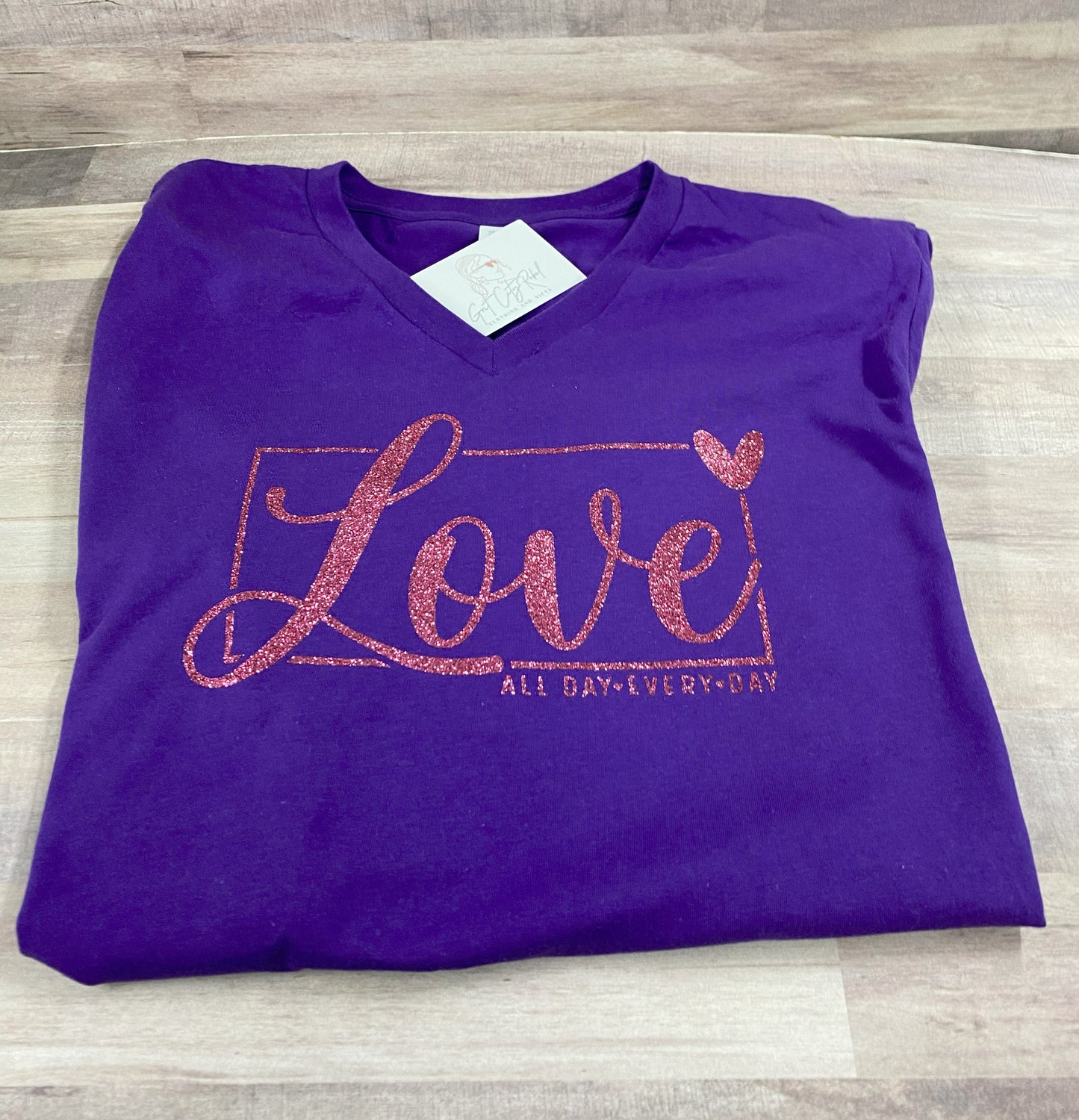 Grit City Rebel January 2025 VIP Monthly T-shirt in purple with the phrase love all day every day in pink glitter in sizes small to 3xl. 