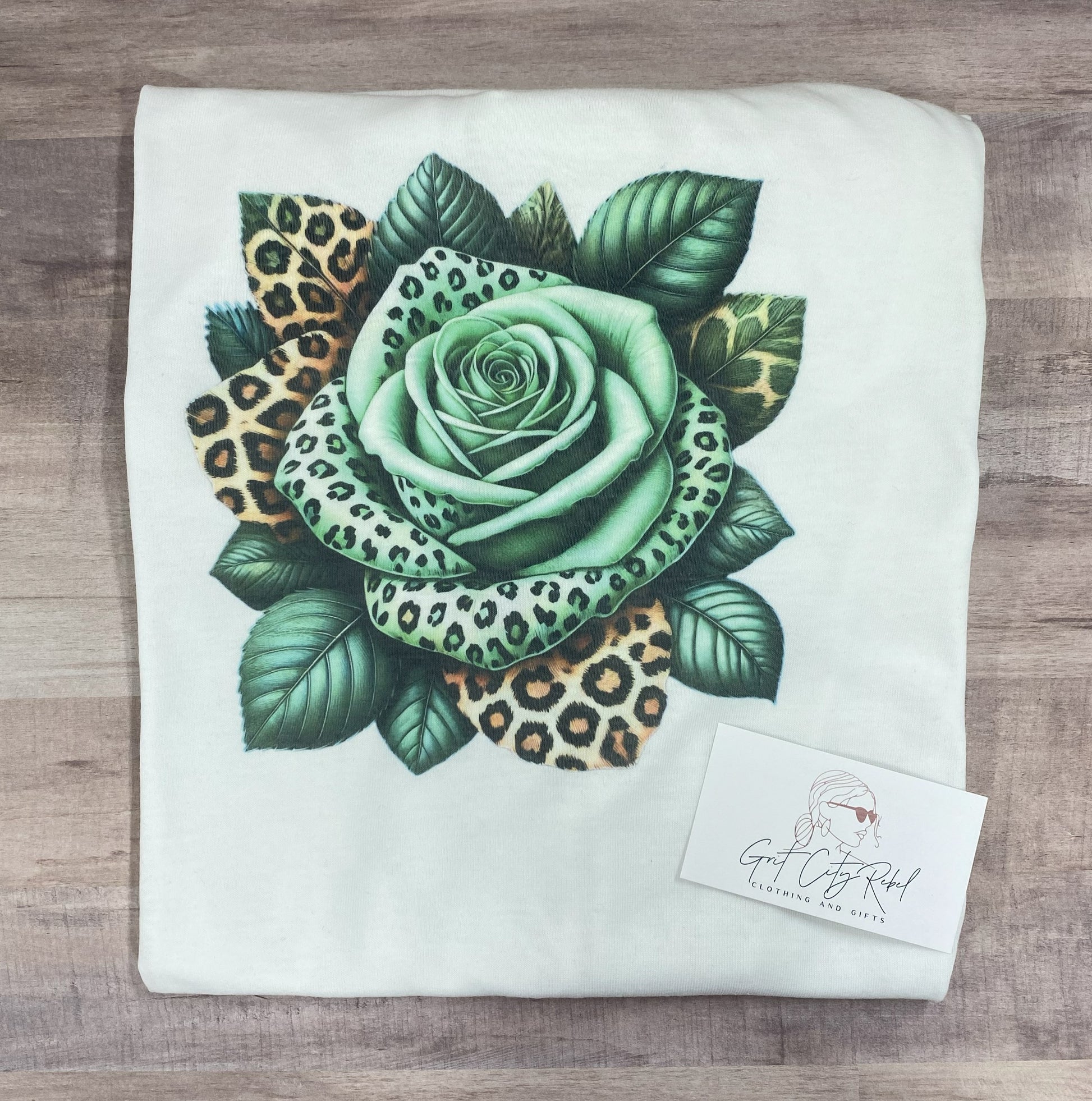 grit city rebel unisex white tshirt with a green and leopard print rose. sizes small to 3xl.