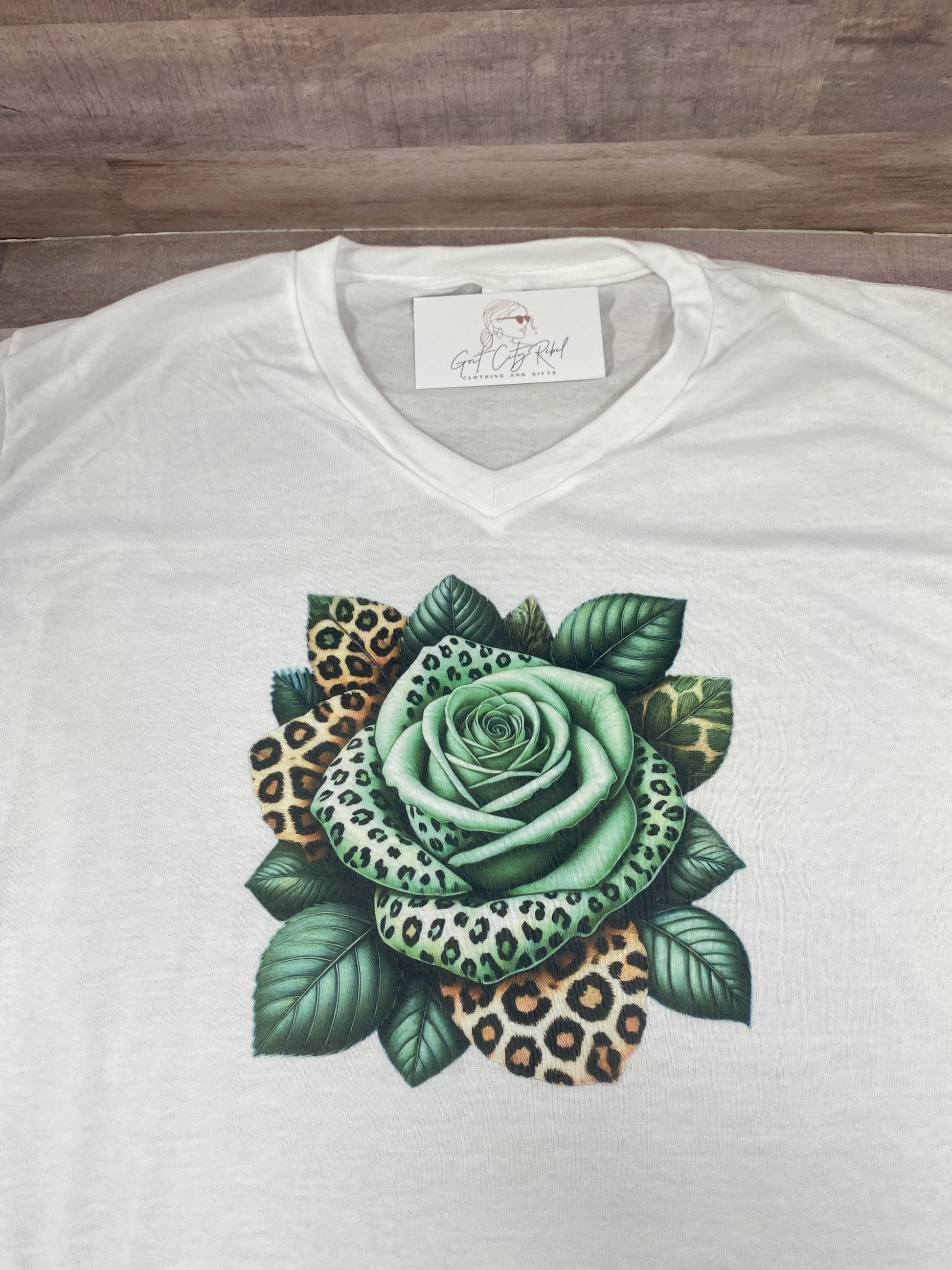 grit city rebel unisex white tshirt with a green and leopard print rose. sizes small to 3xl.