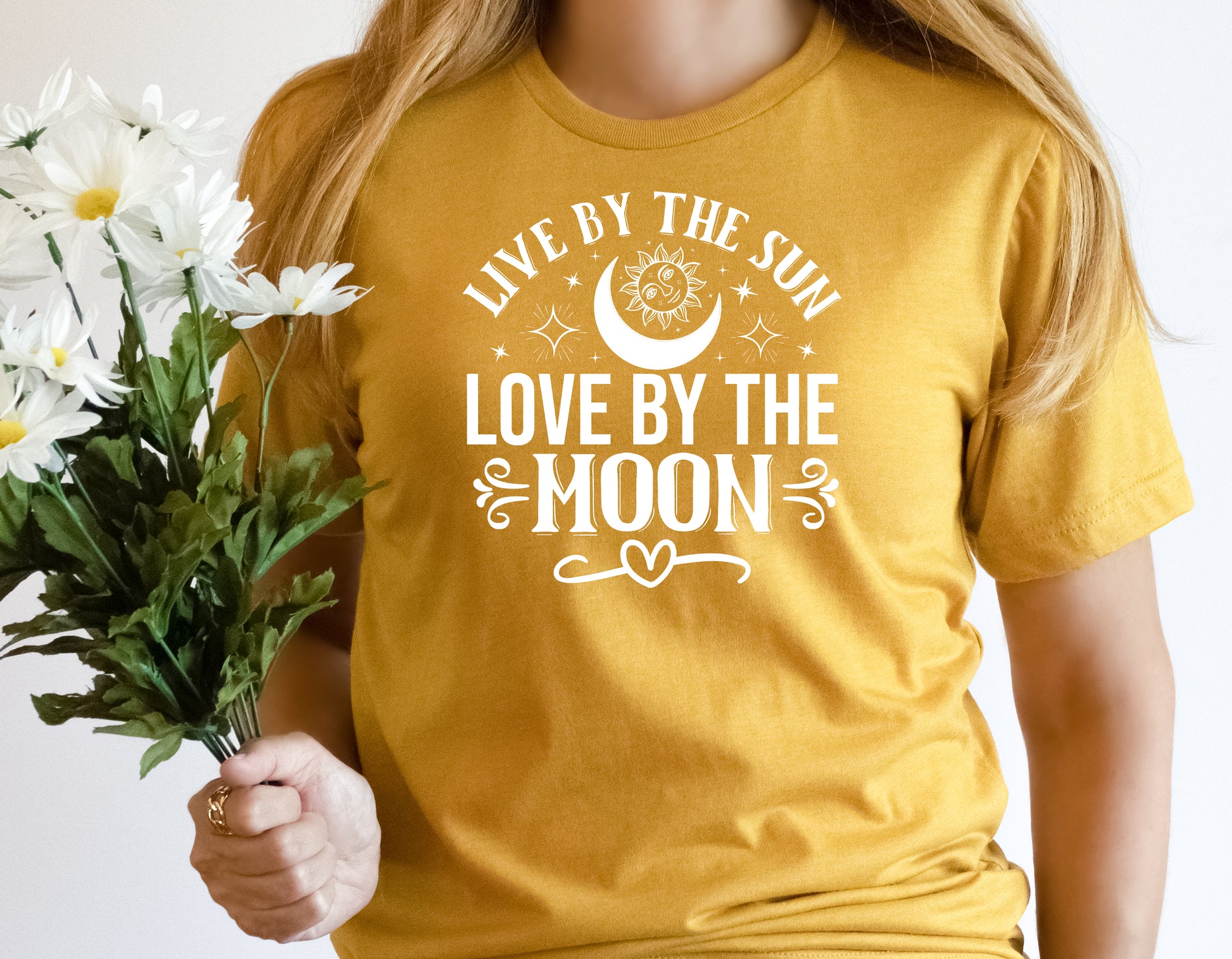 grit city rebel unisex t-shirt in a dark mustard yellow with the phrase live by the sun love by the moon with stars, a moon and a sun.  Available in sizes from small to 3xl. 