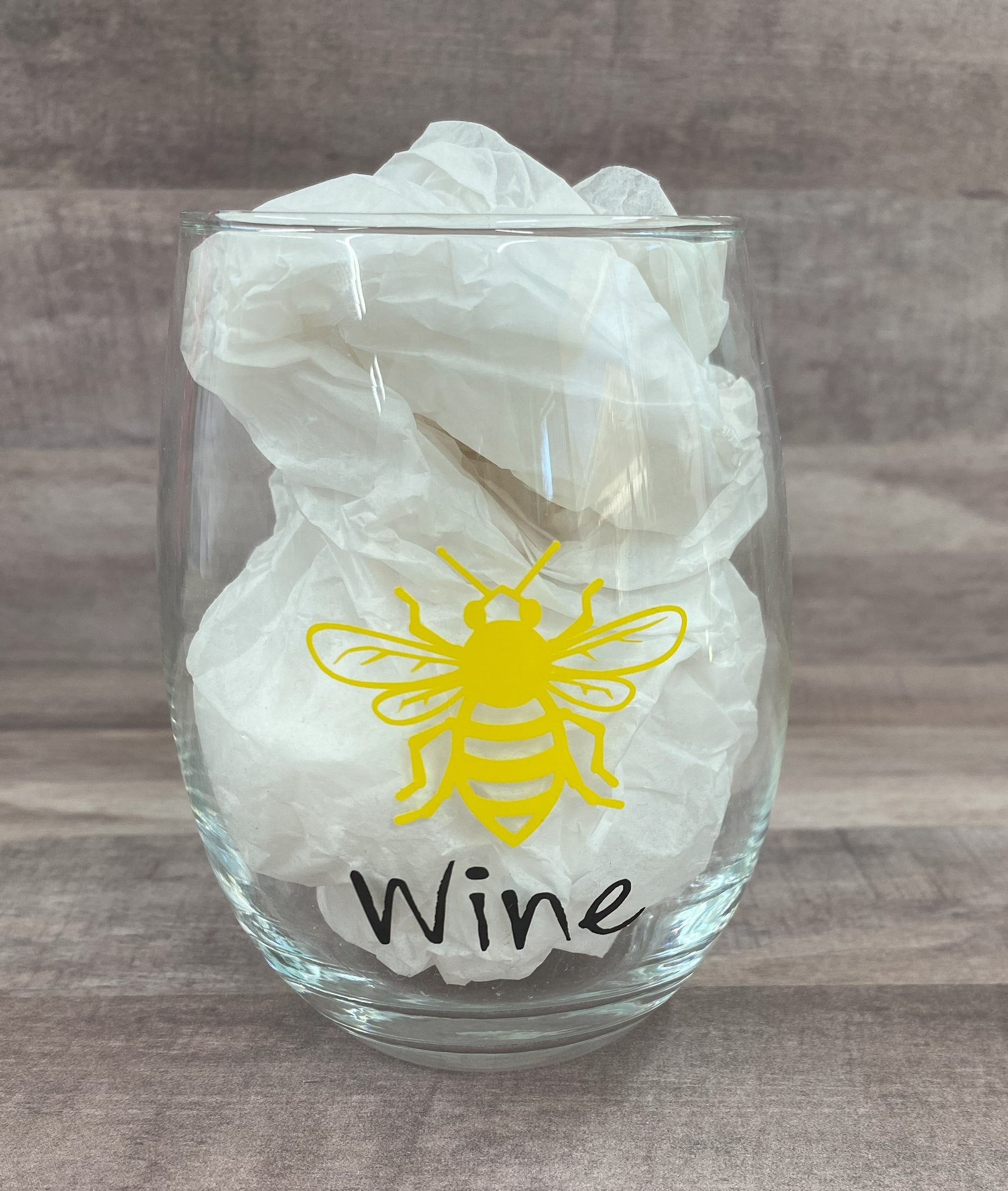 Stemless 15oz wine glass with the a bee outline in yellow with the word wine in black writing Customizable. Designed by Grit City Rebel.