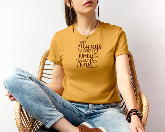 grit city rebel unisex t-shirt of the month in a yellow t-shirt with the phase "always stay humble and kind" in a brown vinyl