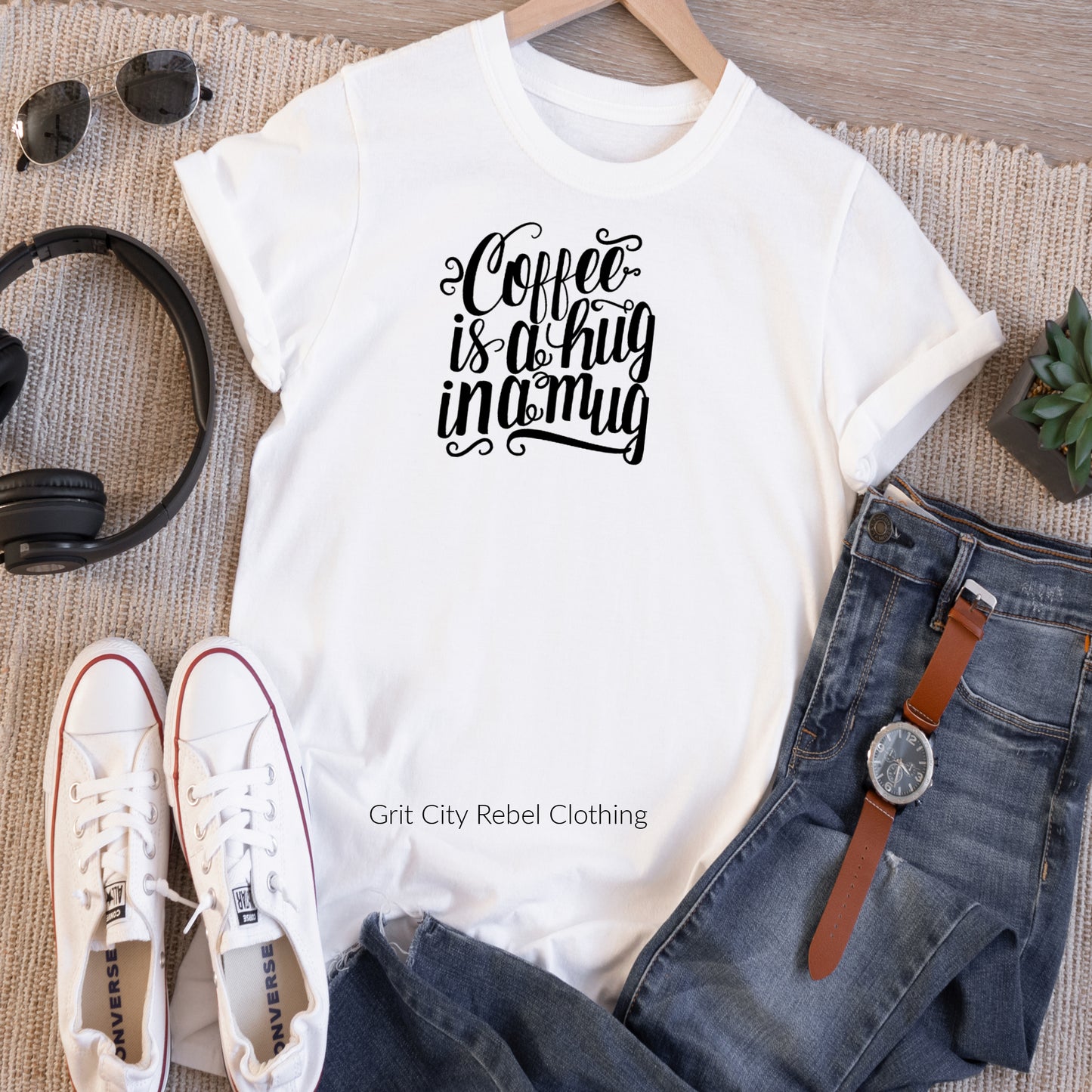 White short sleeve unisex  T-Shirt with the saying coffee is a hug in a mug in black writting