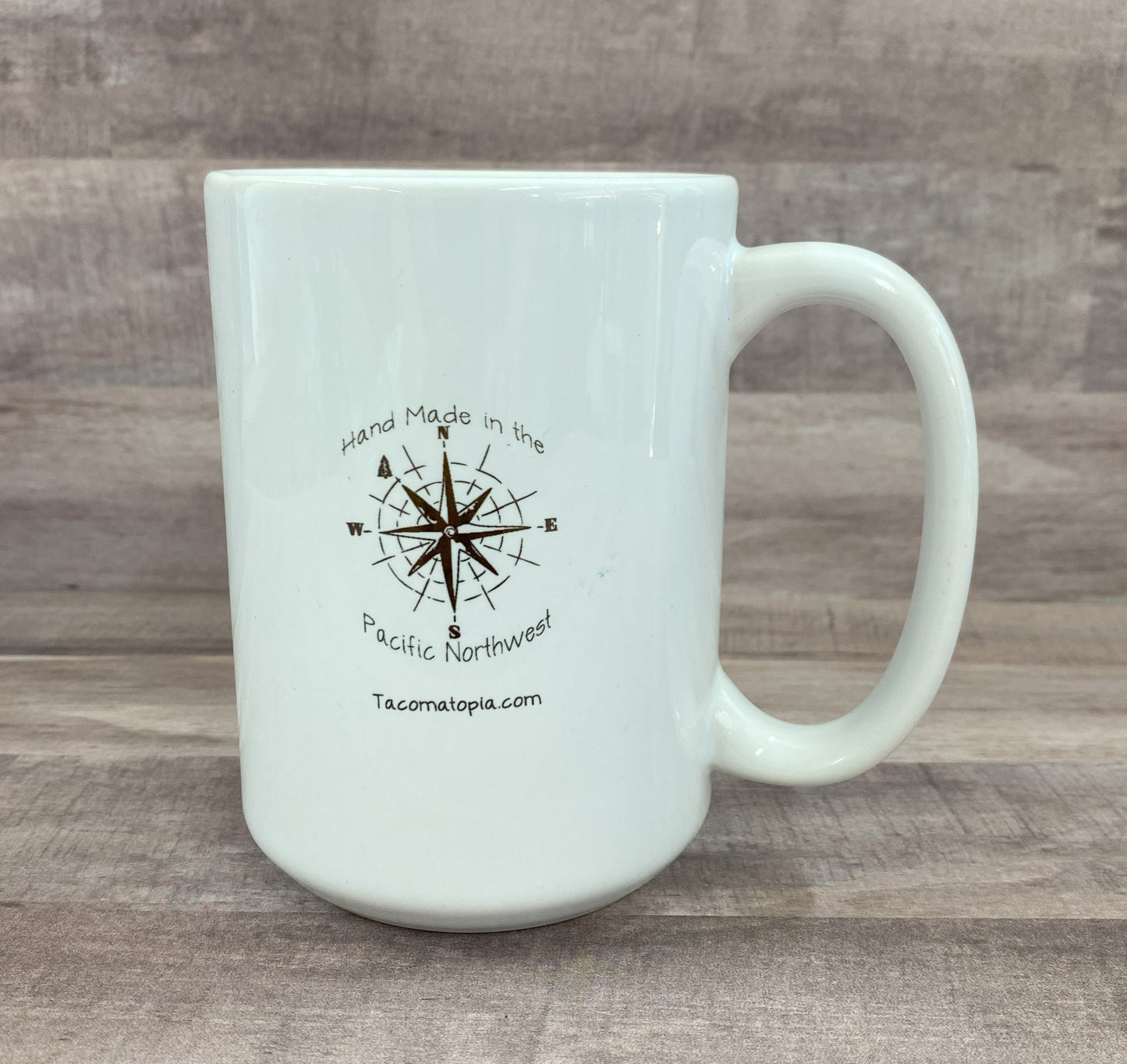 16oz ceramic mug with a blue watercolor image of a crab - grit city rebel back of the mug has handmade in the pacific northwest