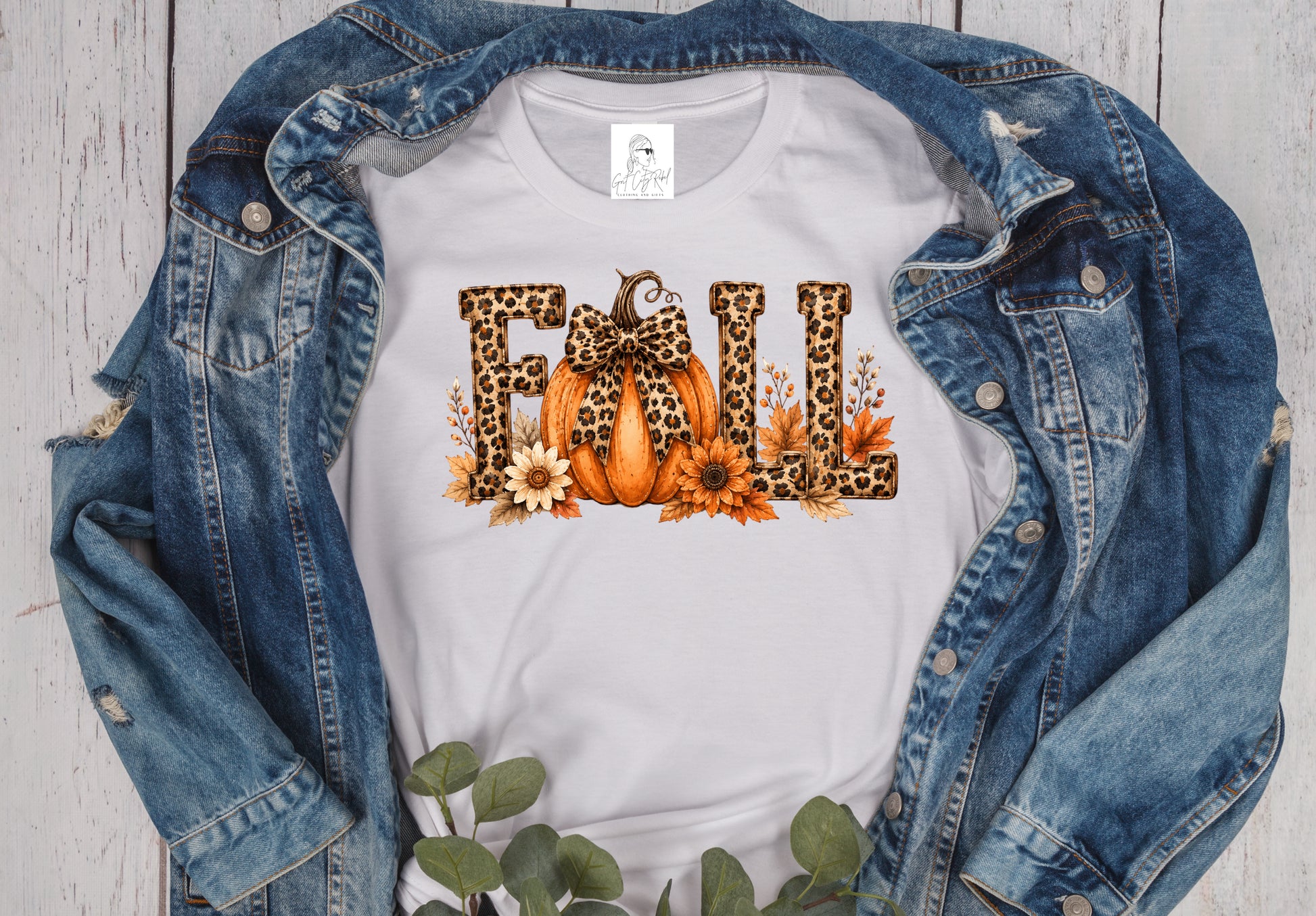 Grit City Rebel unisex t-shirt in white with a graphic of the word fall.  The letters (f, l, l) are in a leopard print and the a is replaced with a pumpkin with a leopard bow. Available in sizes small to 3xl. 