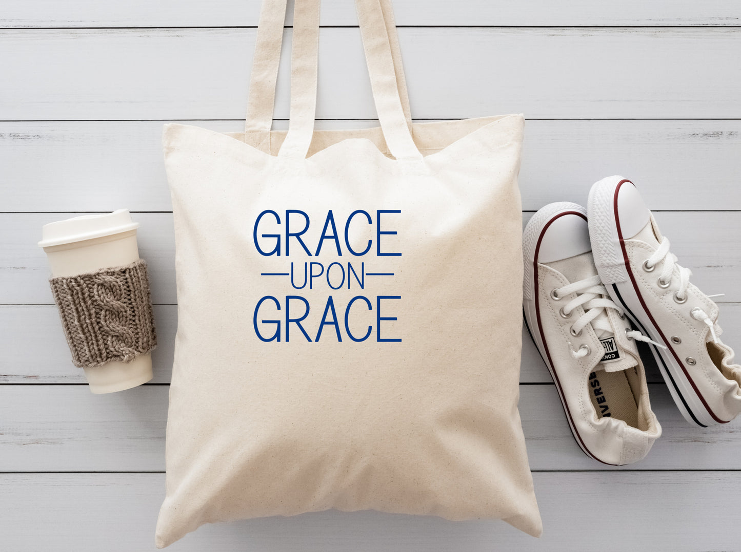 Cream cloth tote bag with the saying Grace Upon Grace in blue