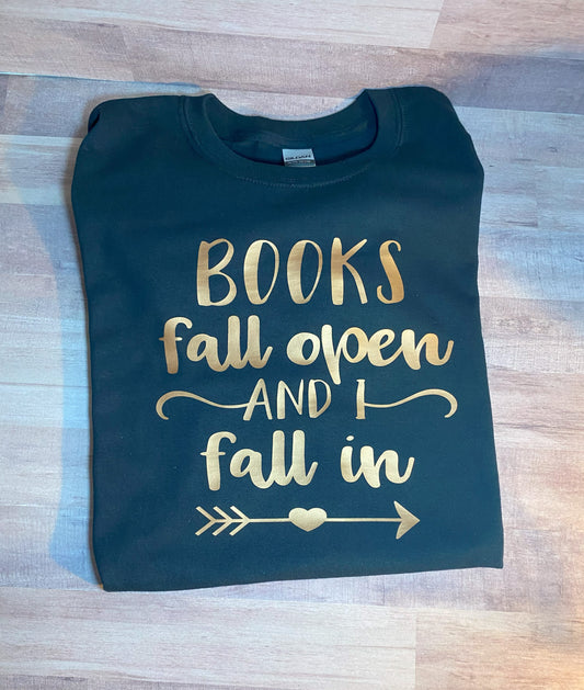 Black cotton T-shirt with the saying Books fall open and I fall in with a arrow and heart below the saying all in copper colored writing Grit City Rebel sizing unisex sizes small medium large Xlarge 2X 3X