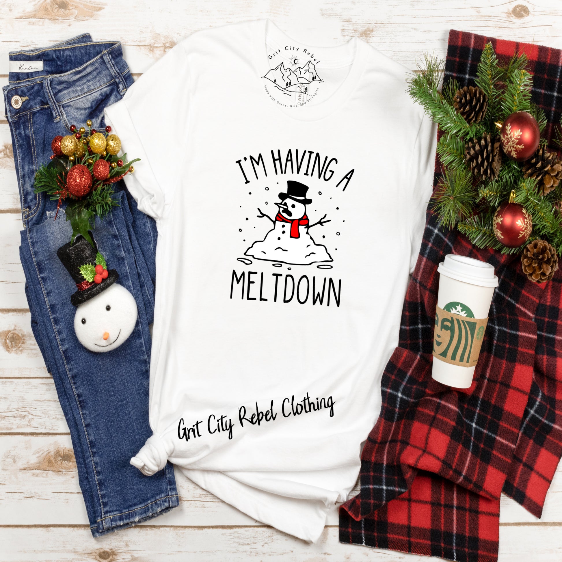 white short sleeve T-Shirt with a snowman melting and the saying I'M Having A Meltdown in black writting