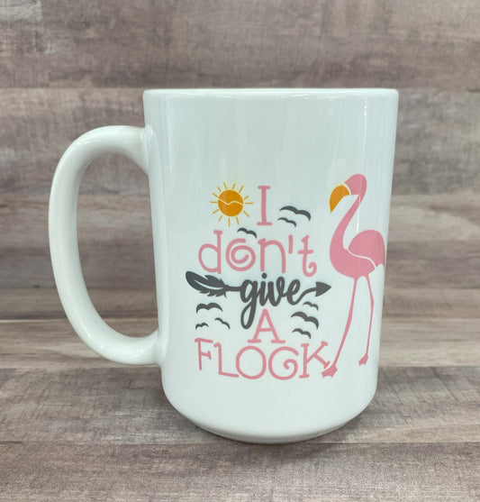 16oz ceramic mug with a pink flamingo image with the phrase i don't give a flock on both side - grit city rebel