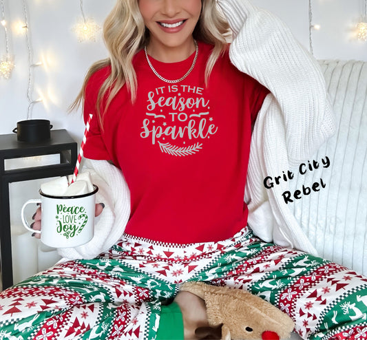 red T-shirt with grey glitter vinyl in the saying It is the season to sparkle. Comes in sizes small to 3X. Grit City Rebel