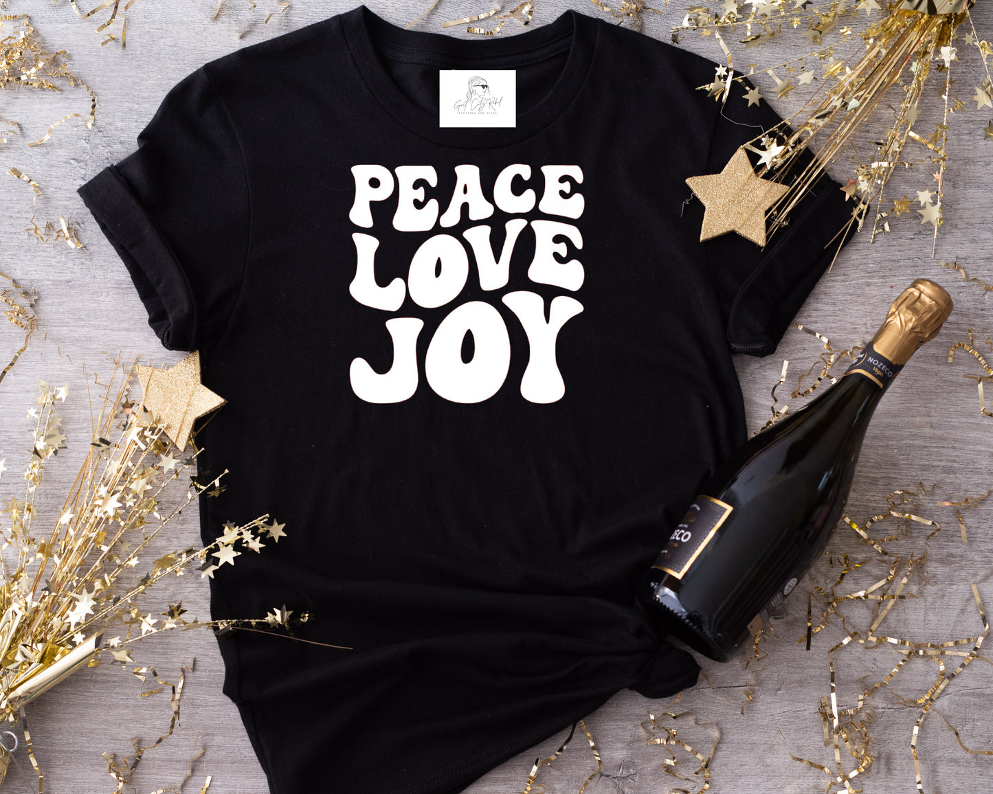 grit city rebel unisex black t-shirt with the phrase peace love joy in white vinyl retro writing.  available in sizes small to 3xl.