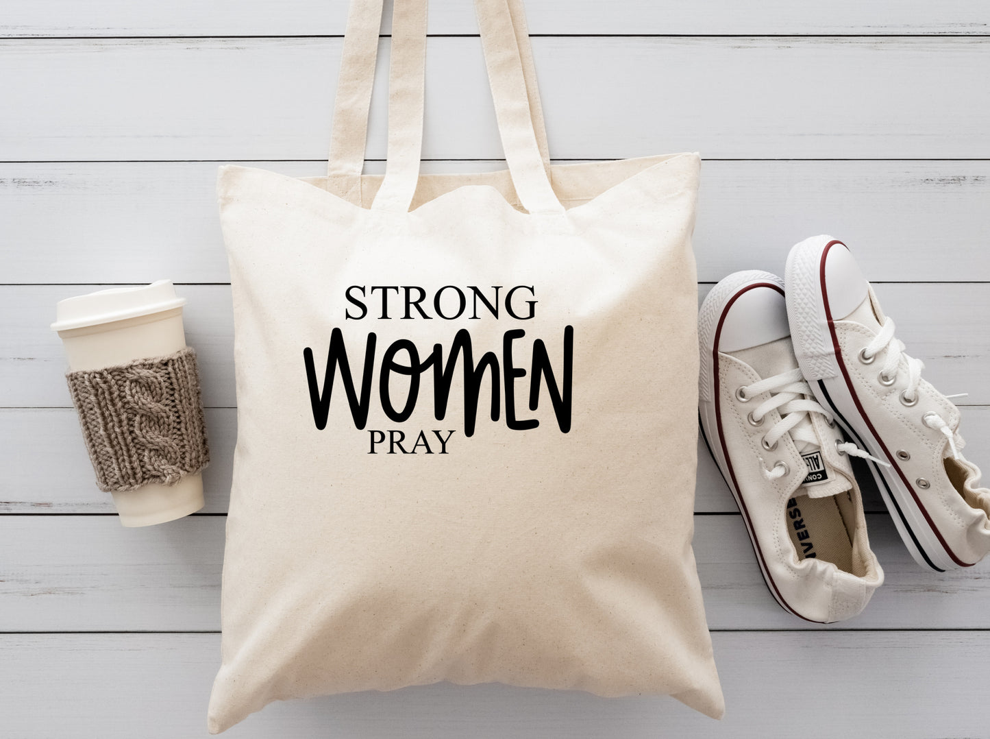 Cream colored reuseable tote bag with the saying Strong WOMEN Pray in black writting