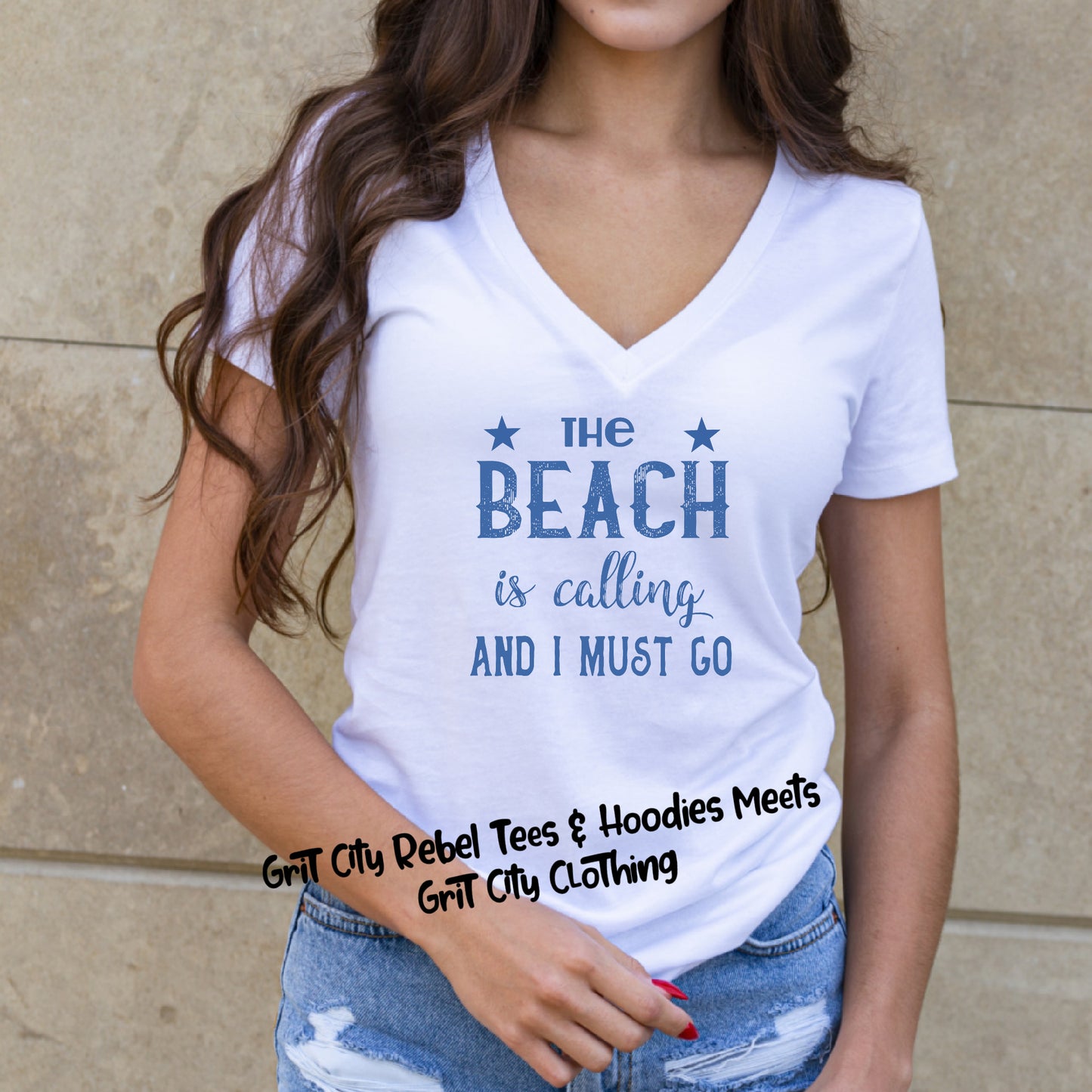 White unisex TShirt with the saying the Beach Is CallingAnd I must Go in blue writting.