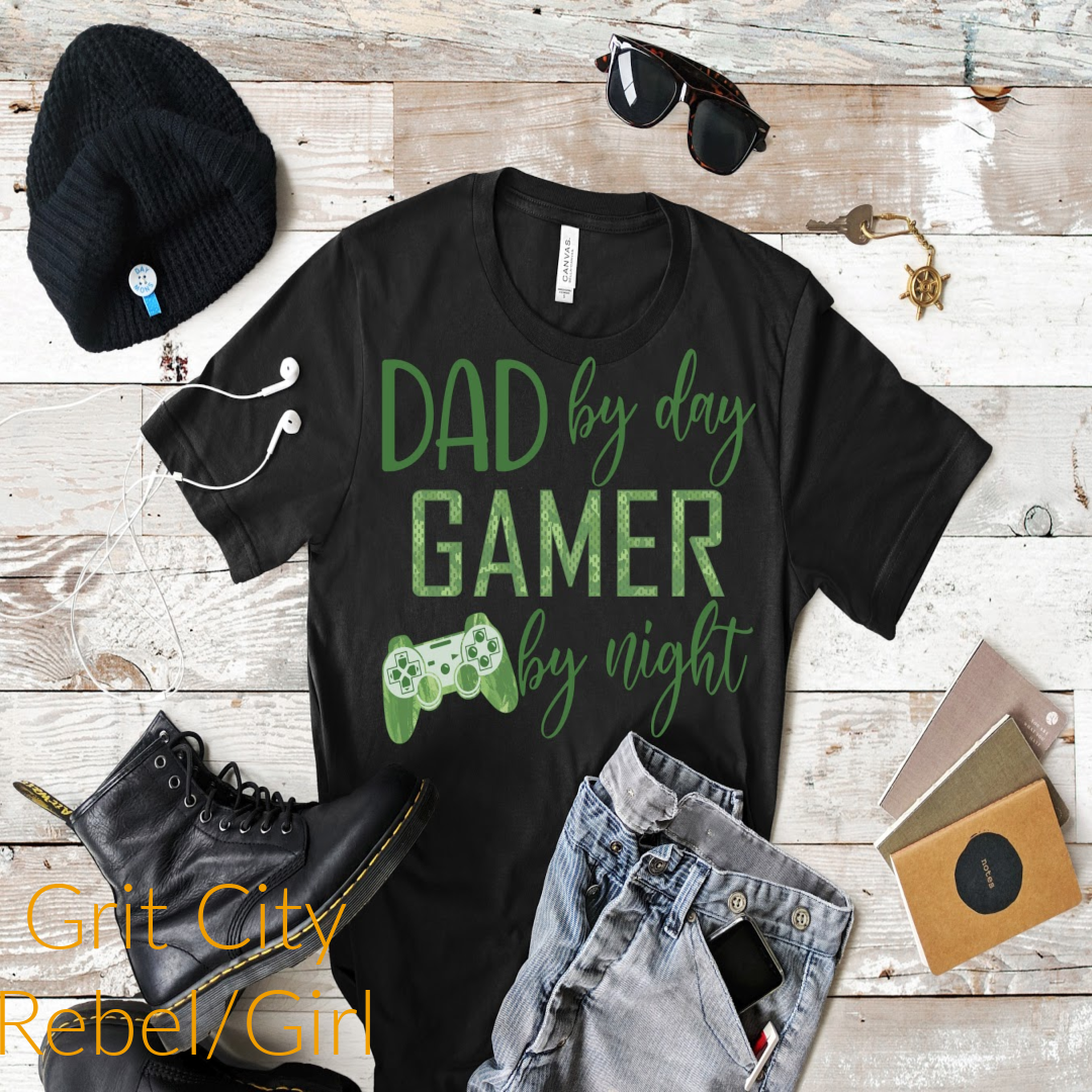Grit City Rebel black shirt with green writing Dad by day gamer by night sizing unisex sizes small, medium, large, Xlarge, 2X, 3X