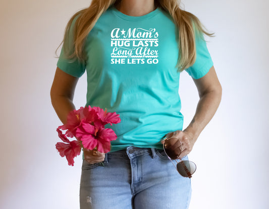 Turquoise short sleeve unisex T-Shirt with the saying A Mom's Hug Lasts Long Agter She Let's Go