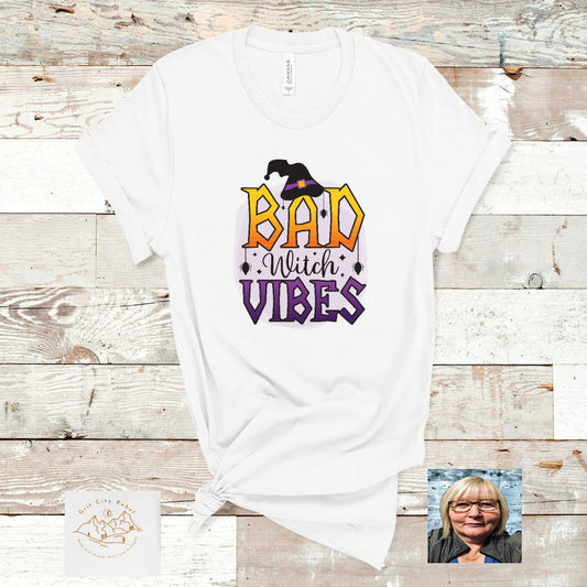 white short sleeve unisex T-Shirt with the saying Bad Witch Vibes in purple yellow and orange
