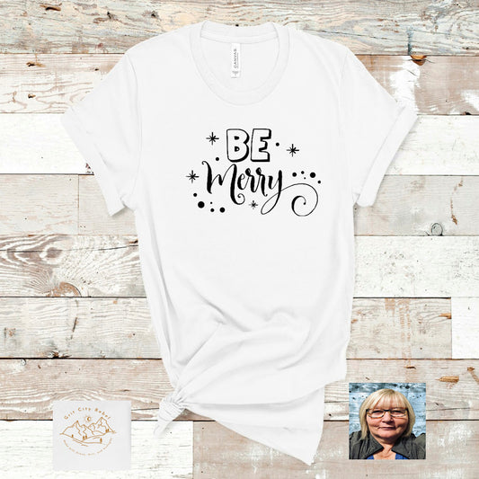 White cotton short sleeve TShirt with the saying Be Merry