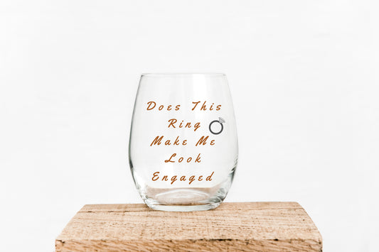 15oz Wine glass with the saying I Does this ring make me look engaged in black writing Grit City Rebel