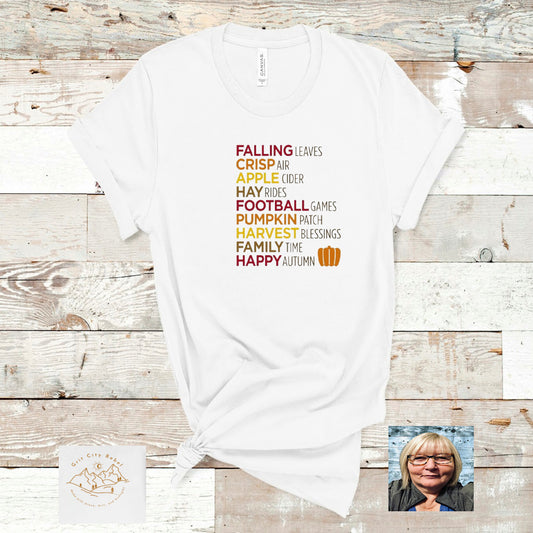White unisex short sleeve tshirt with Fall words in Fall colors listed on the front Grit City Rebel sizing unisex sizes small medium large Xlarge 2X 3X