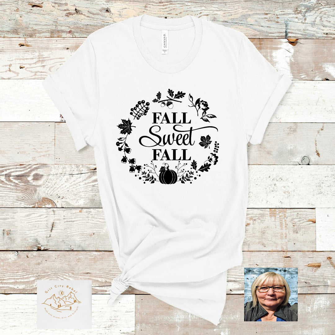 Fall sweet Fall surrounded be a circle of leaves and pumpkins all in black on a white Tshirt Grit City Rebel sizing unisex sizes small medium large Xlarge 2X 3X