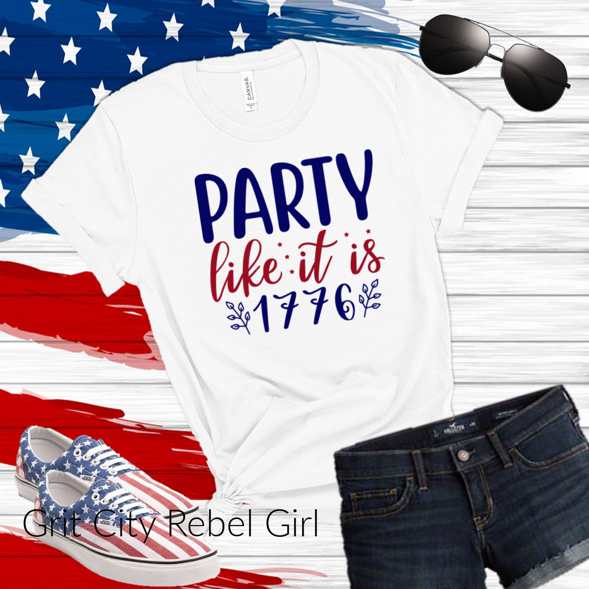 White T-Shirt with the saying in red and navy of Party like it is 1776 with leaf accents in navy
