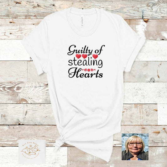 Grit City Rebel White TShirt With the saying Guilty of stealing Hearts in black writting with red hearts. unisex sizing in small to 3X