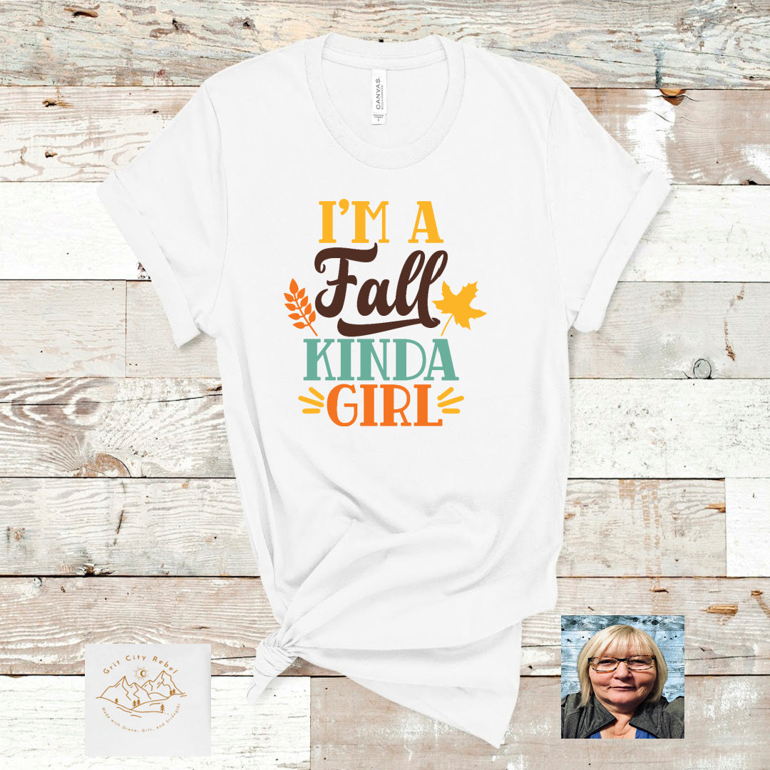 I'm a fall kinda girl in Fall colors of gold, brown, Teal and orange writing on a white Tshirt.  Grit City Rebel sizing unisex sizes small medium large Xlarge 2X 3X 