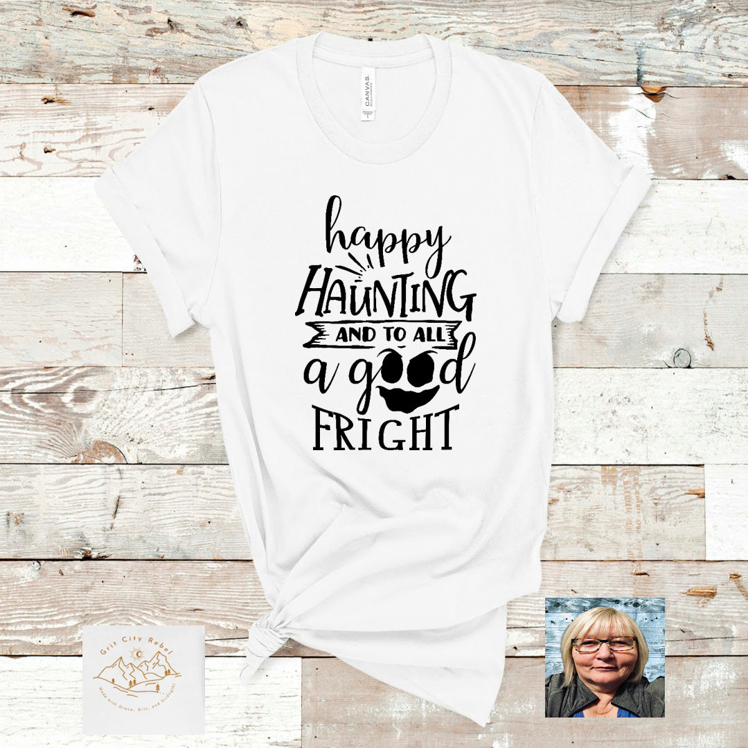 white Tshirt  with the saying happy haunting and to all a good fright