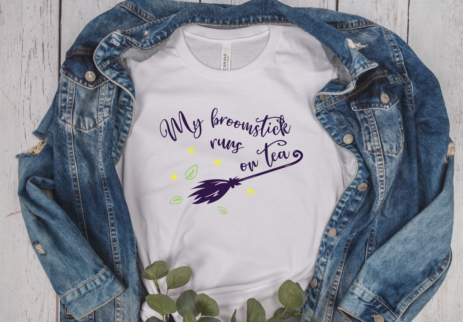 white short sleeve unisex T-Shirt with the written My broomstick runs on tea in purple