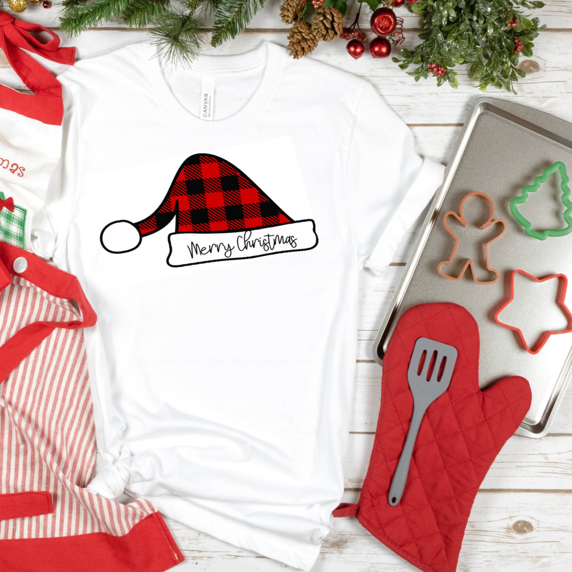 White Short Sleeve Unisex T-Shirt with a Buffalo Plaid Santa hat and merry christmas on the white rin in black writting